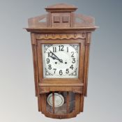 An early 20th century oak cased eight day wall clock.