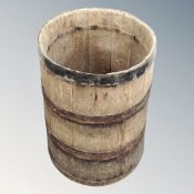An antique oak coopered barrel.
