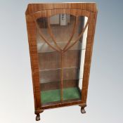 A 1930s display cabinet on claw and ball feet.