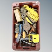 A plastic crate containing tools, lamps, spanners, rope etc.
