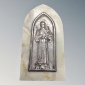 A white metal embossed religious icon mounted on marble.