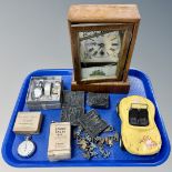A tray containing an antique mantel clock, metal figures, chrome plated stopwatch,