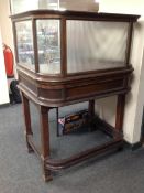 A 19th century shop display stand on raised legs.