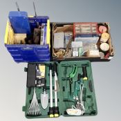 A plastic crate containing tools, hand tools, a box of hardware, screws,