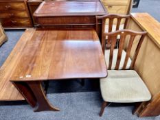 A 20th century G plan drop leaf table together with a pair of rail back chairs in a mahogany finish.