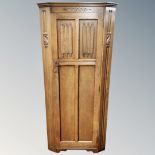 An oak linen fold hall wardrobe.