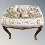 A French carved beech dressing table stool upholstered in a tapestry fabric.