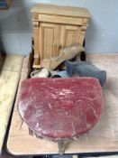 A box containing vintage wooden clogs, an upholstered stool on tripod legs,