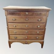 A 19th century inlaid mahogany and oak five drawer chest with brass drop handles and pillar column
