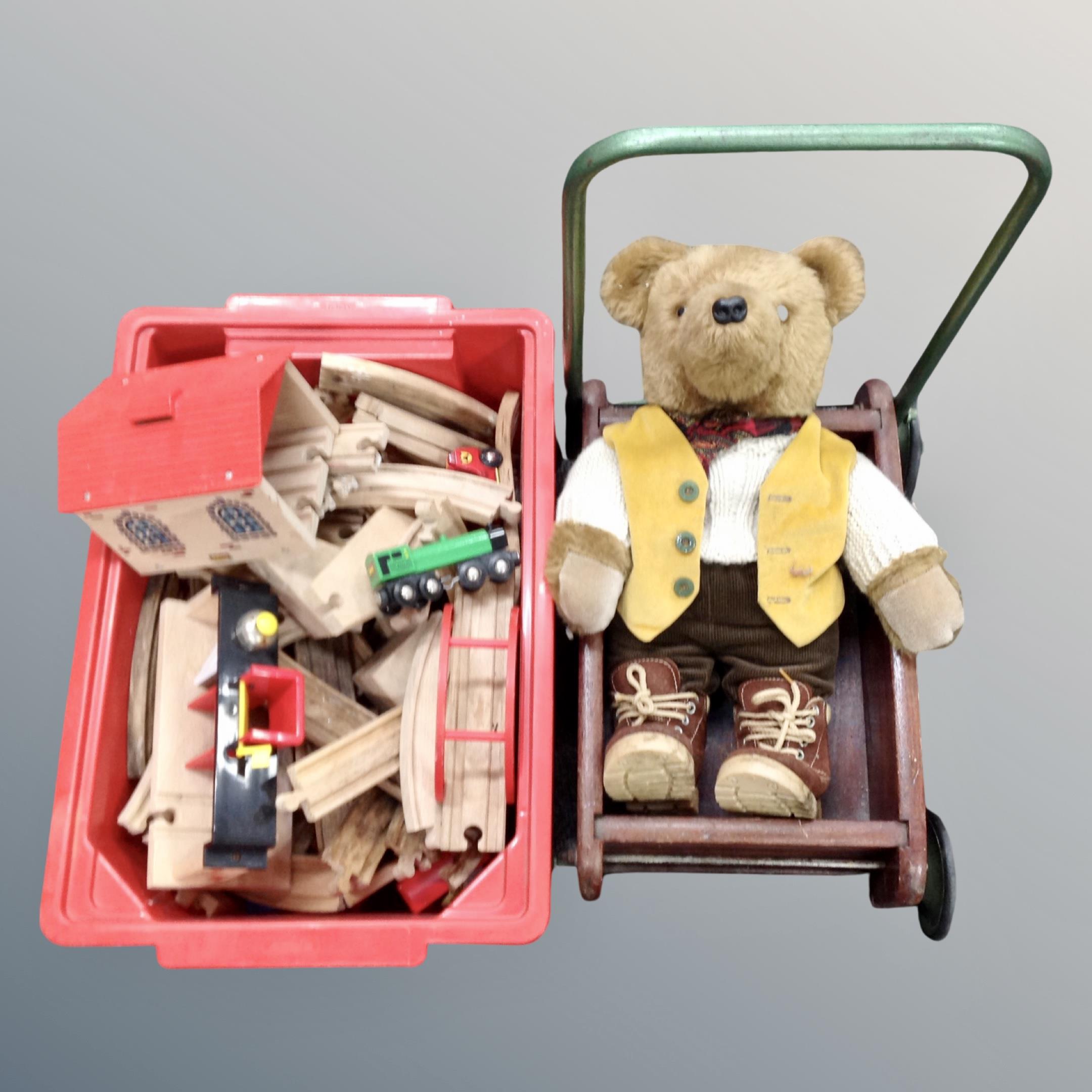 A box containing wooden Brio train set and buildings together with a child's wooden cart containing