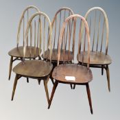 A set of five Ercol elm and beech spindle back dining chairs in an antique finish together with a