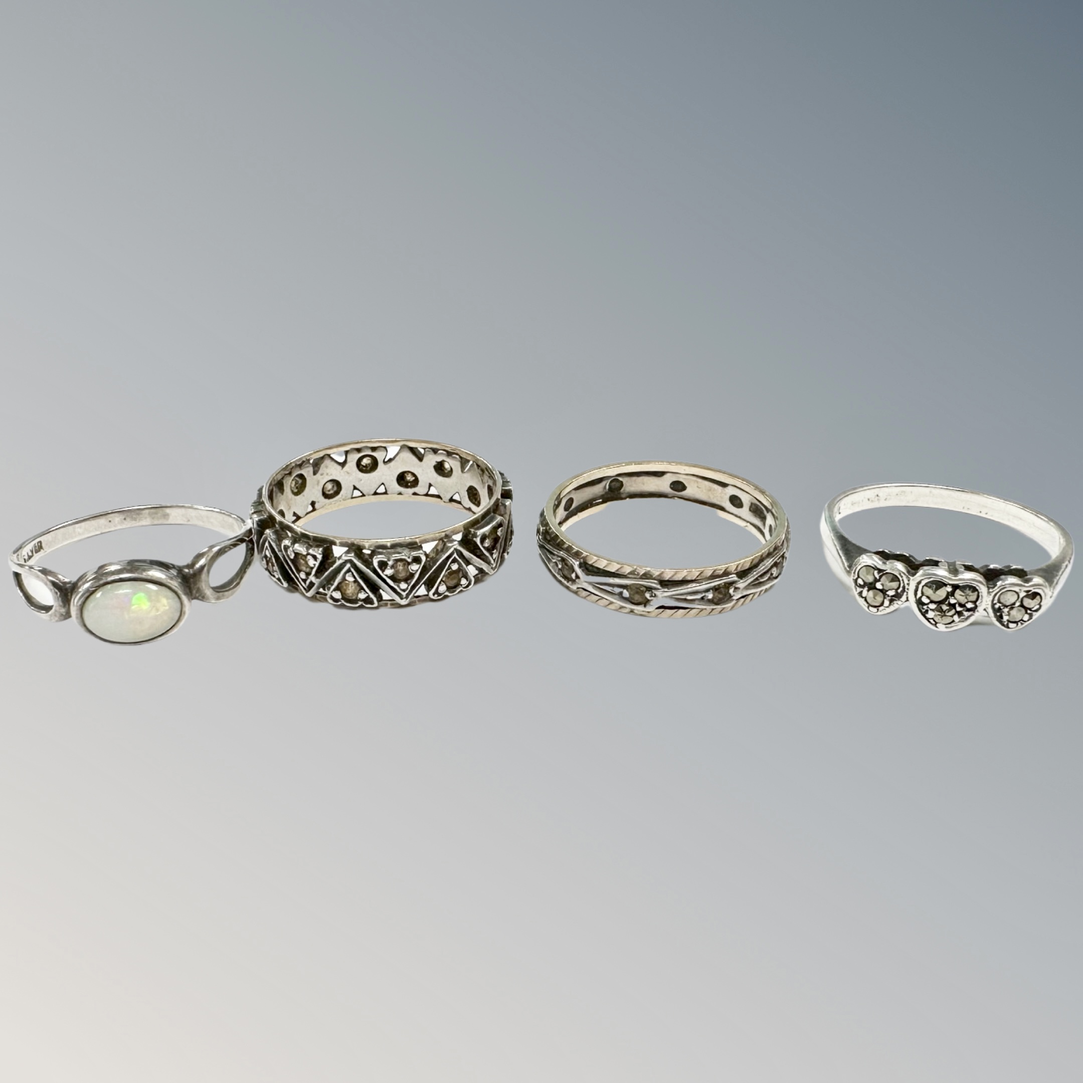 A 9ct gold and silver band ring together with a further band ring similar and two silver rings.