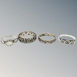 A 9ct gold and silver band ring together with a further band ring similar and two silver rings.