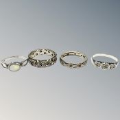 A 9ct gold and silver band ring together with a further band ring similar and two silver rings.