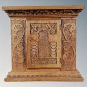 A 19th century heavily carved oak wall cabinet.