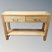 A contemporary oak two tier side table fitted with two drawers.