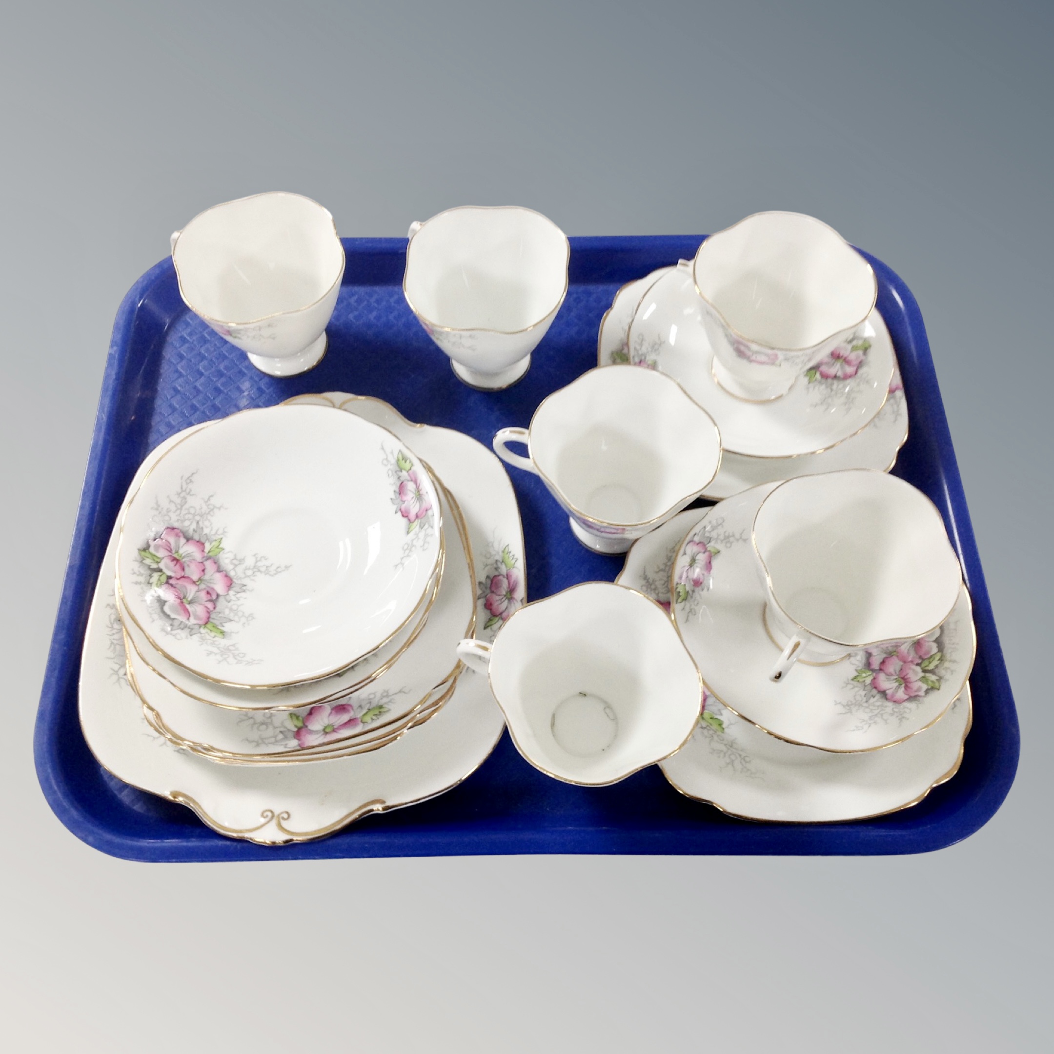 A tray containing a Windsor floral gilded bone china tea set.