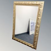 A decorative bevel edged mirror in gilt frame.