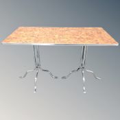 A retro style kitchen table on twin metal pedestals.