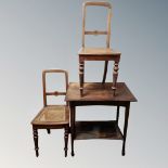 An Edwardian oak two tier occasional table together with a pair of bergere seated bedroom chairs.