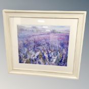 A contemporary print of a meadow in frame and mount.