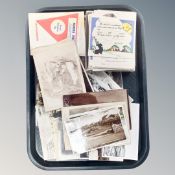 A tray containing antique and later monochrome photographs and postcards including scenes of