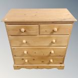 A pine two over three five drawer chest with knob handles.