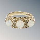 A 9ct yellow gold three stone opal ring set with diamonds, size M/N, 3.7g.