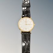 A Raymond Weil 18ct gold plated Gentleman's wrist watch on black leather strap.