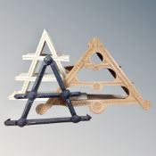 A tramp art triangular wall shelf together with two further wall shelves.