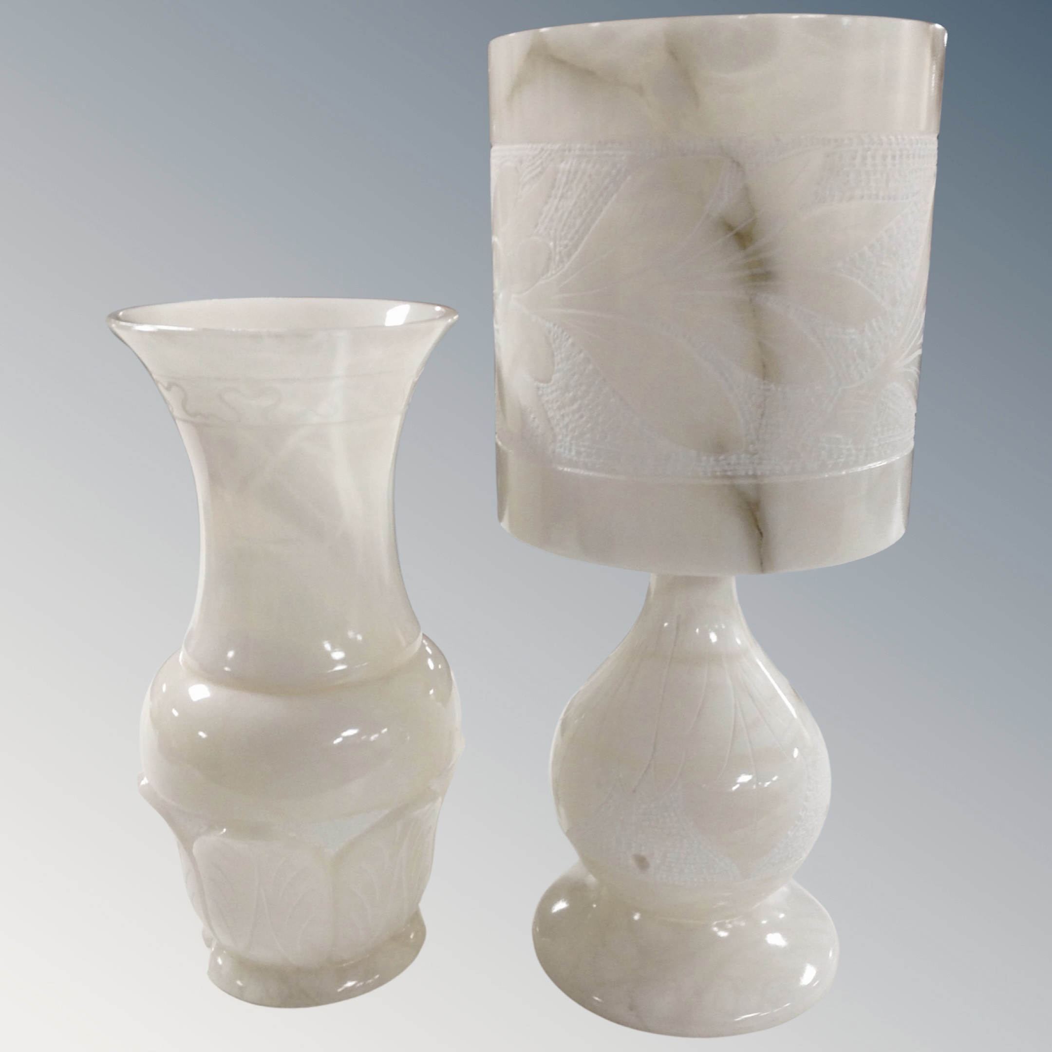 An alabaster table lamp with shade (height 42cm), together with a further alabaster table lamp.