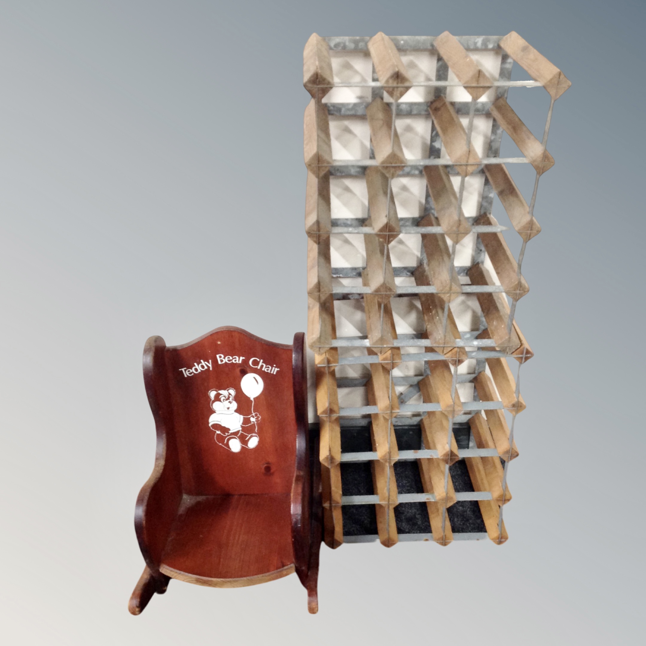 Two 12-bottle wine racks together with a stained pine child's rocking chair.