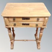 A 19th century pine two drawer work table.