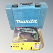 A Bosch electric drill together with a lamp and a Makita storage box.