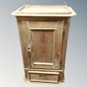 An antique pine wall cabinet fitted with a drawer.