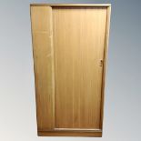 A mid-20th century teak gentleman's wardrobe with shutter door.