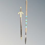 A reproduction ceremonial sword together with an African spear.