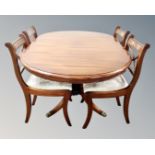 A good quality reproduction mahogany flap sided dining table and four chairs