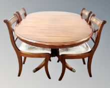 A good quality reproduction mahogany flap sided dining table and four chairs