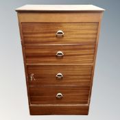 A mid-20th century four drawer vanity chest in a teak finish.