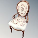 A 19th century mahogany open lady's chair upholstered in a tapestry fabric on cabriole legs.