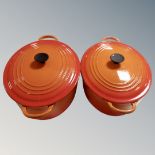 Two Le Creuset cast iron lidded casserole pans.