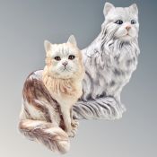 Two ceramic cat figures.