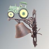 A cast iron bell on tractor wall bracket.