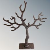 A cast iron jewellery hanging stand in the form of a tree.