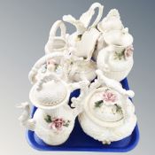 A tray containing eight pieces of Italian Capodimonte flower encrusted china including teapots,