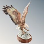 A Guiseppe Armani figure of a golden eagle.