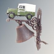 A cast iron bell on Land Rover wall bracket.
