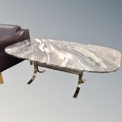 An oval marble coffee table on metal legs