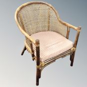 A bamboo and wicker tub chair